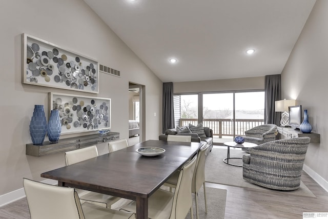 dining space featuring high vaulted ceiling, recessed lighting, wood finished floors, visible vents, and baseboards