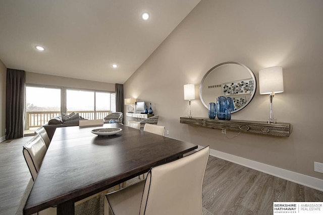 dining room with high vaulted ceiling, recessed lighting, baseboards, and wood finished floors