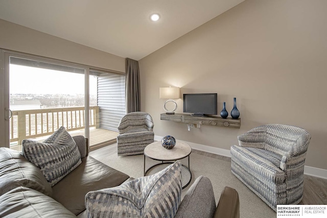 living room featuring lofted ceiling, recessed lighting, baseboards, and wood finished floors