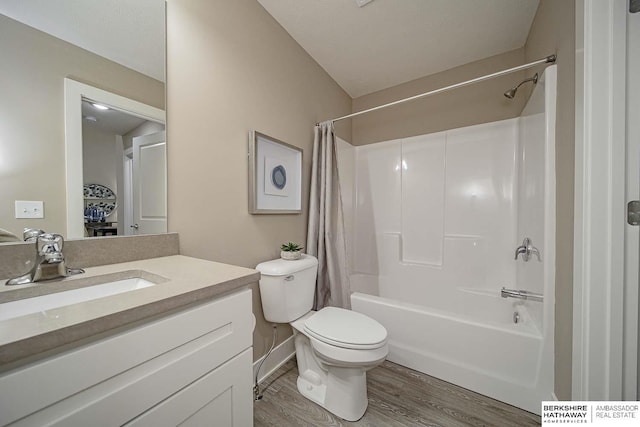 bathroom with vanity, shower / bathtub combination with curtain, toilet, and wood finished floors