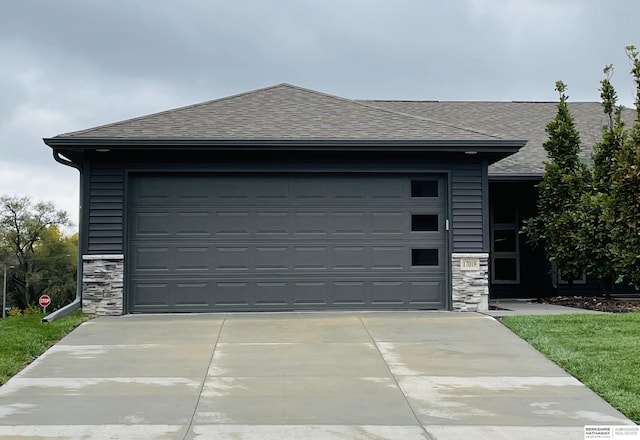 garage featuring concrete driveway