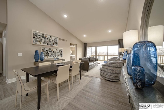 dining space with high vaulted ceiling, recessed lighting, wood finished floors, visible vents, and baseboards