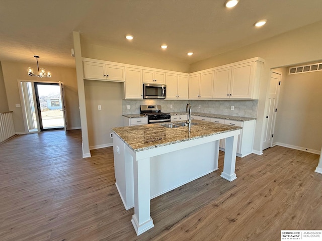 kitchen featuring white cabinetry, visible vents, appliances with stainless steel finishes, and a sink