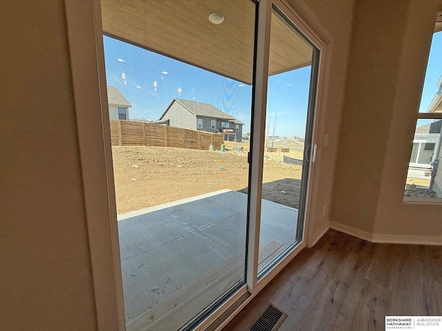 entryway with wood finished floors and baseboards