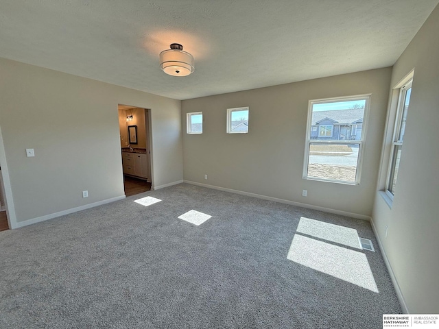 empty room with visible vents, baseboards, and carpet floors