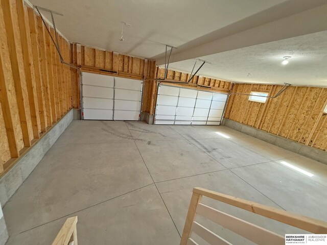 garage featuring wood walls