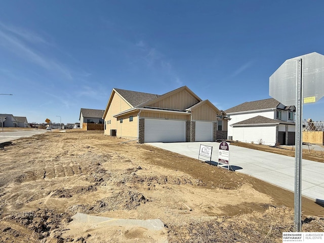 view of home's exterior with a garage, board and batten siding, and concrete driveway