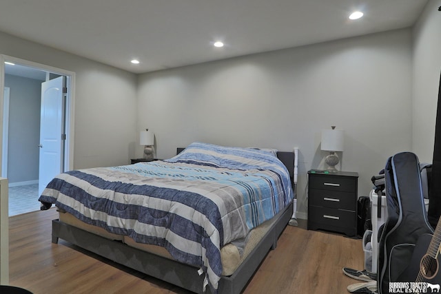 bedroom with dark wood-type flooring and recessed lighting