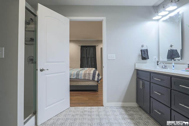 full bathroom featuring ensuite bathroom, an enclosed shower, vanity, and baseboards