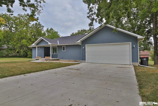 ranch-style home with a front yard and a garage