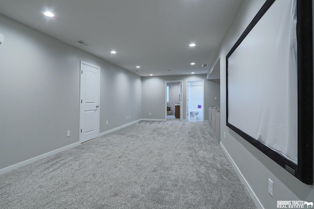 unfurnished room with baseboards, light carpet, visible vents, and recessed lighting