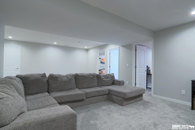 living area with recessed lighting, baseboards, and light colored carpet