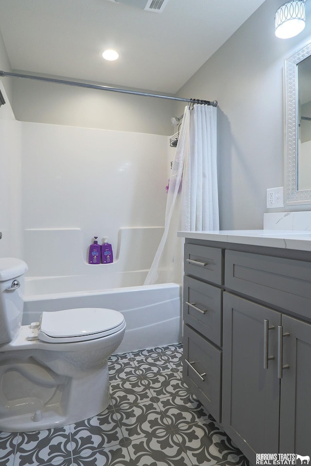 bathroom featuring shower / bath combination with curtain, visible vents, toilet, vanity, and tile patterned flooring