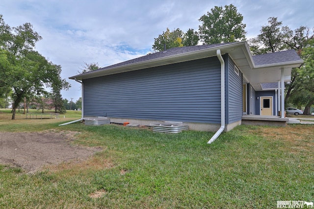 view of property exterior featuring a lawn