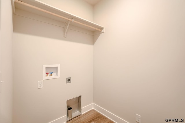 washroom featuring hardwood / wood-style flooring, hookup for an electric dryer, and hookup for a washing machine