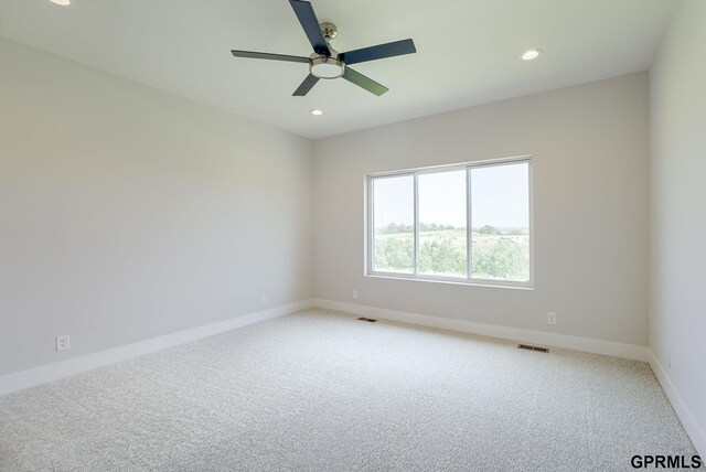 carpeted empty room with ceiling fan