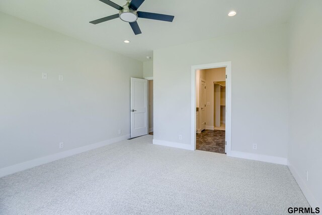 unfurnished bedroom featuring ceiling fan and carpet