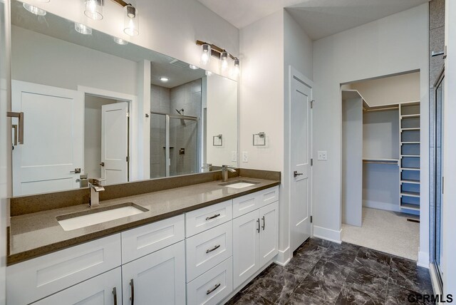 bathroom featuring tile patterned flooring, walk in shower, and vanity