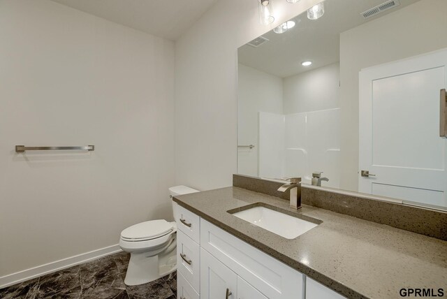 bathroom with tile patterned floors, toilet, walk in shower, and vanity