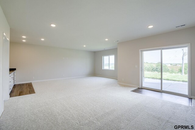 unfurnished living room with light carpet