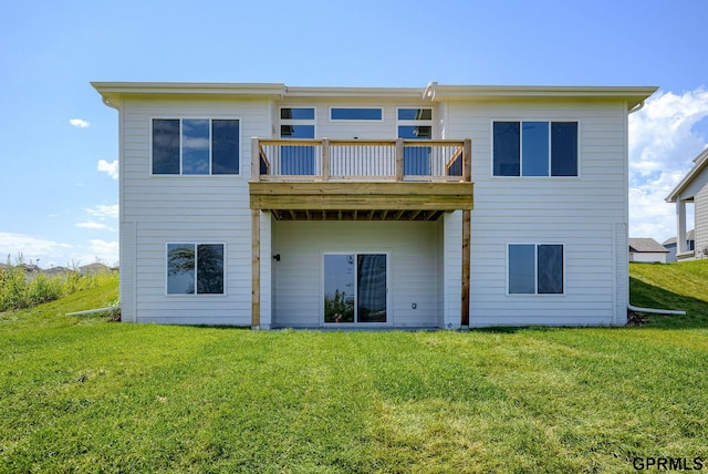 back of house with a balcony and a lawn