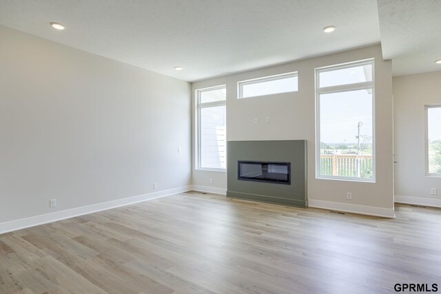 unfurnished living room with light hardwood / wood-style flooring