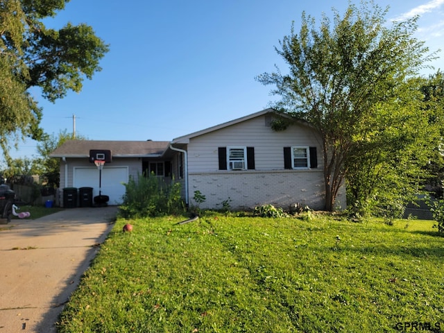 ranch-style house featuring a front yard and a garage