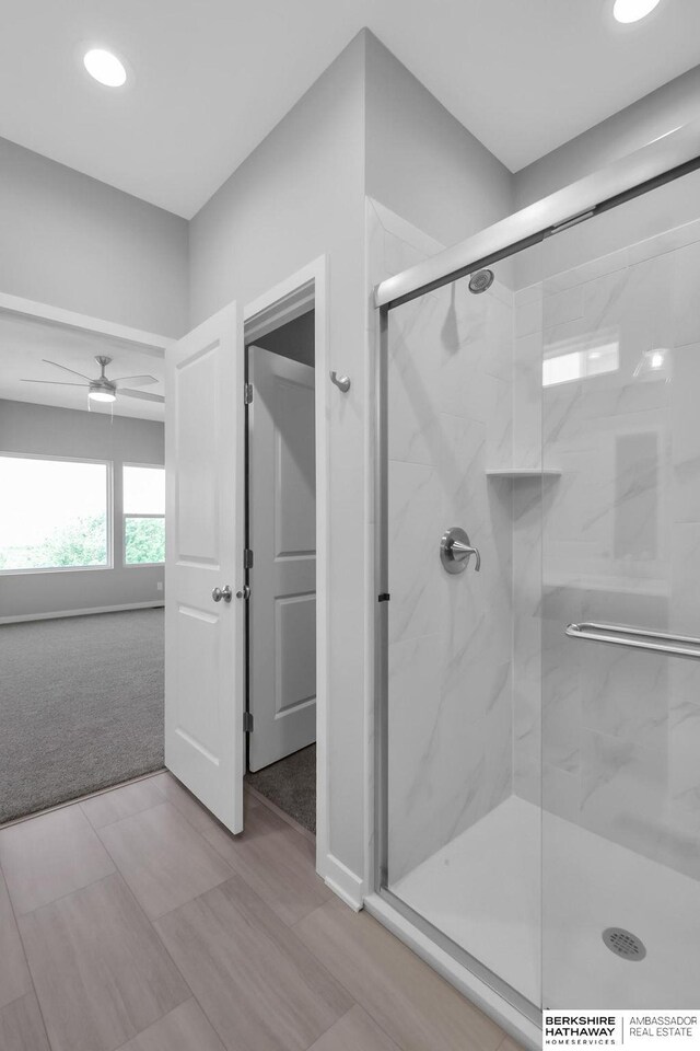 10210 S 110th Ave, Papillion, NE 68046 - full bath featuring a marble finish shower, a ceiling fan, wood finished floors, and recessed lighting