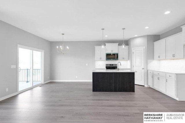 10210 S 110th Ave, Papillion, NE 68046 - kitchen with appliances with stainless steel finishes, tasteful backsplash, recessed lighting, light countertops, and light wood-type flooring
