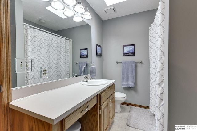 bathroom with tile patterned floors, toilet, and vanity