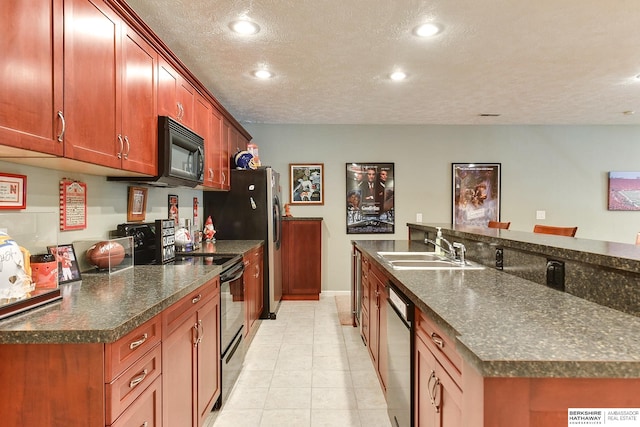 kitchen featuring a textured ceiling, light tile patterned floors, dishwasher, sink, and electric range