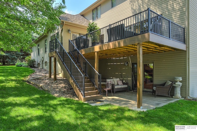 rear view of property featuring outdoor lounge area, a lawn, and a patio