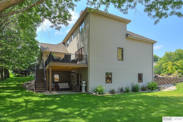 back of house with a yard, a patio area, and a deck