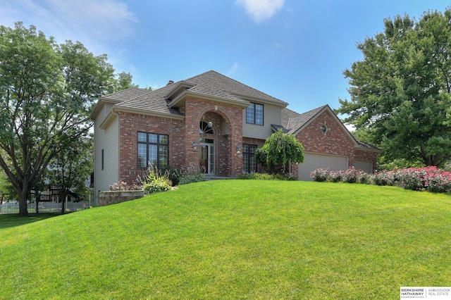 view of front facade featuring a garage and a front lawn