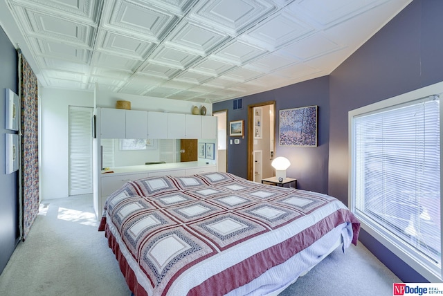 bedroom featuring light carpet