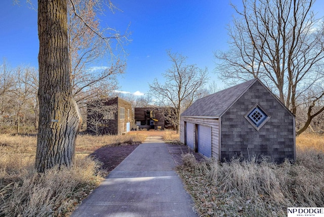 view of home's exterior with an outbuilding and a garage