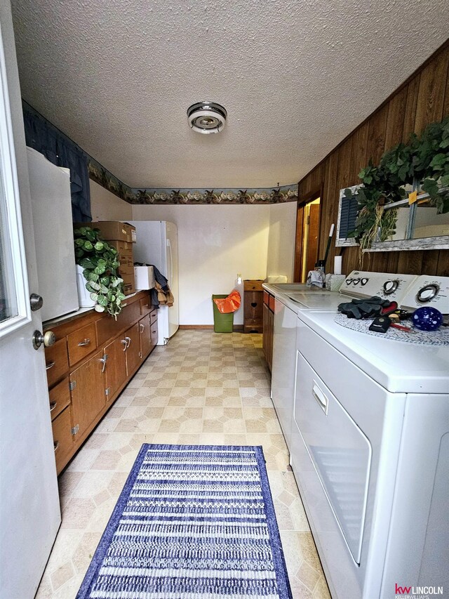 kitchen featuring wood walls and a textured ceiling