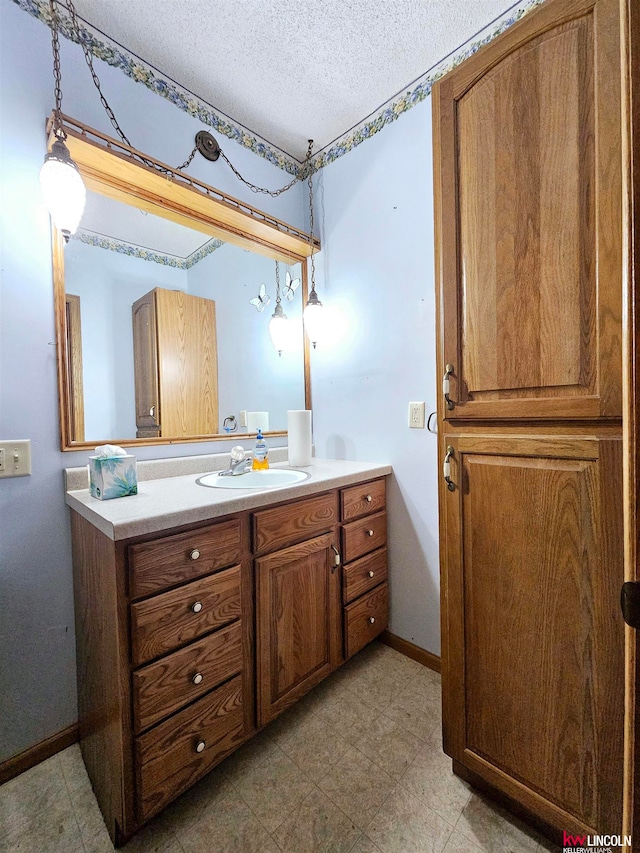 bathroom featuring a textured ceiling and vanity