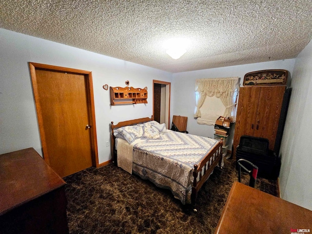 bedroom featuring a textured ceiling, carpet flooring, and a closet