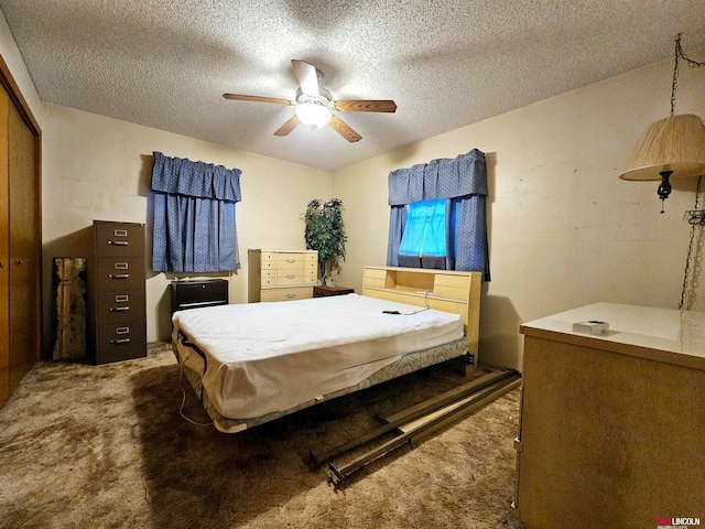 carpeted bedroom with a textured ceiling, ceiling fan, and a closet