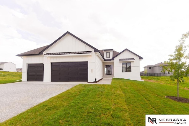 modern farmhouse style home with a front lawn and a garage