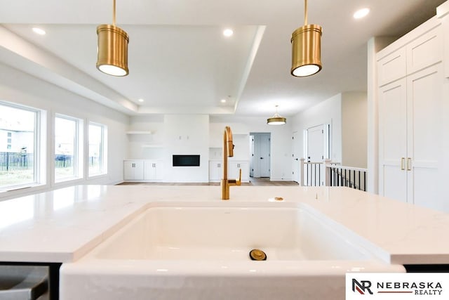 bathroom with a fireplace, a washtub, and recessed lighting