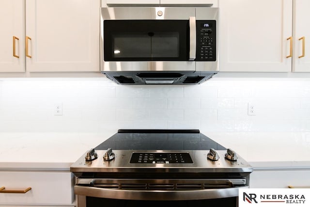 details with white cabinets, stainless steel appliances, backsplash, and light countertops