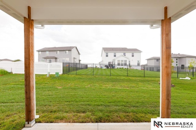 view of yard featuring fence and a residential view