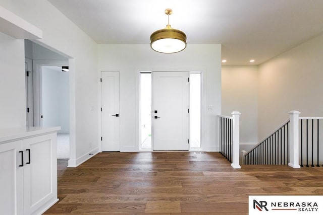 foyer featuring recessed lighting, baseboards, and wood finished floors