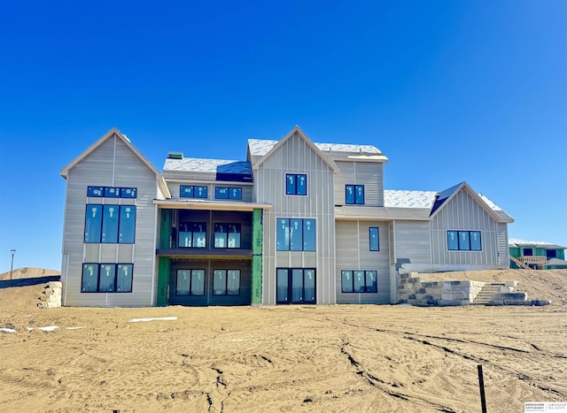 rear view of house featuring board and batten siding