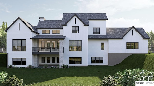 back of house featuring a balcony and a yard