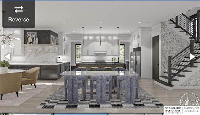 dining room featuring stairway, recessed lighting, and light wood-style flooring