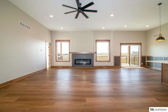 325 S Lakeview Way, Ashland, NE 68003 - unfurnished living room featuring plenty of natural light, a ceiling fan, recessed lighting, a glass covered fireplace, and wood finished floors