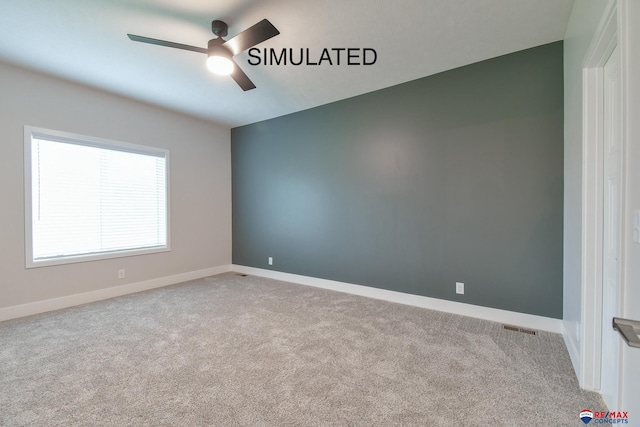 unfurnished room with a ceiling fan, carpet, visible vents, and baseboards